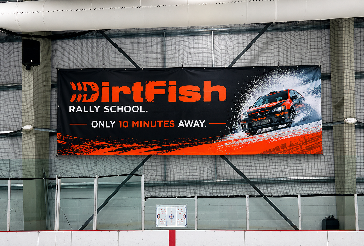 DirtFish Rally School banner hung above the rink — 'Only 10 minutes away.'